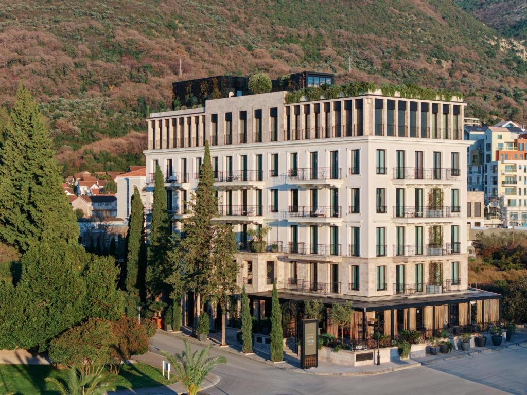 an aerial view of a white building with trees at Porto Palace in Tivat