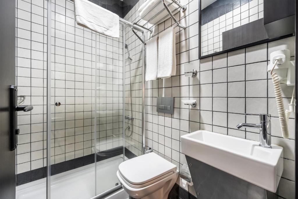 a bathroom with a toilet and a sink at Taksim Terrace Hotel in Istanbul