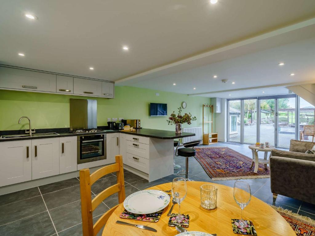 a kitchen and living room with a table and chairs at 1 bed in Cartmel 85499 in Cark