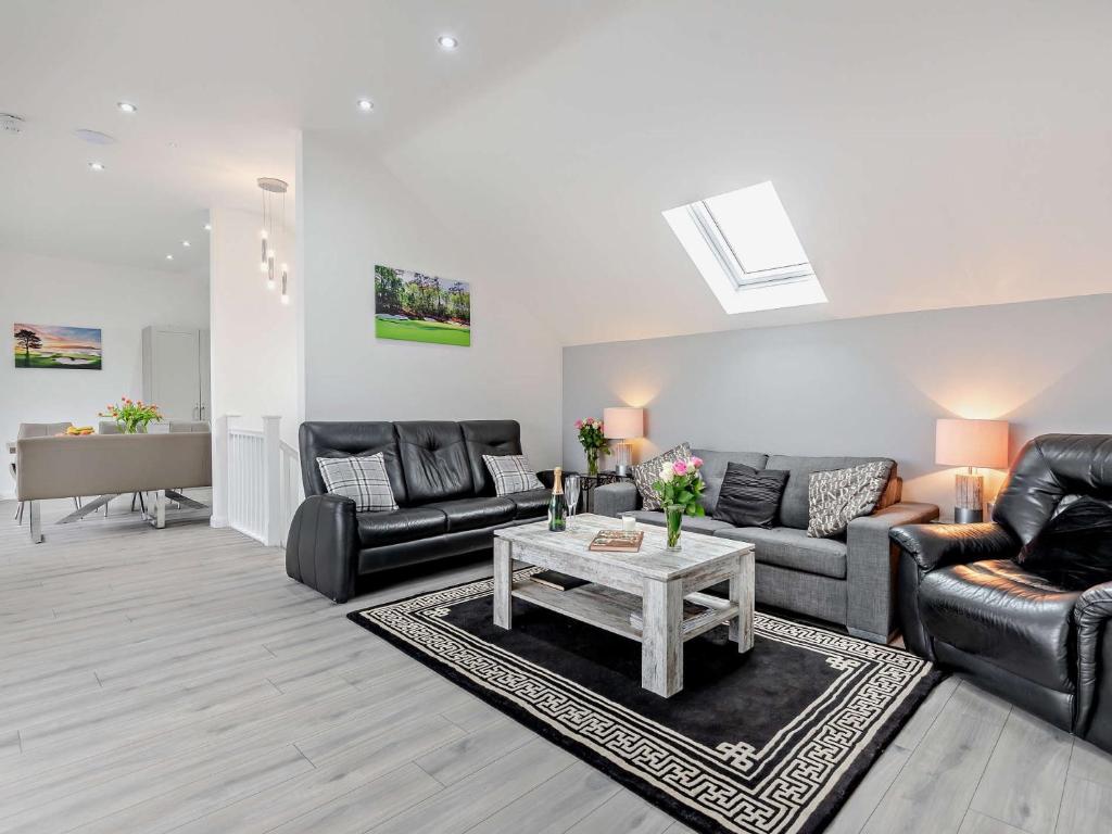 a living room with black leather furniture and a table at 4 Bed in Branston 94516 in Branston