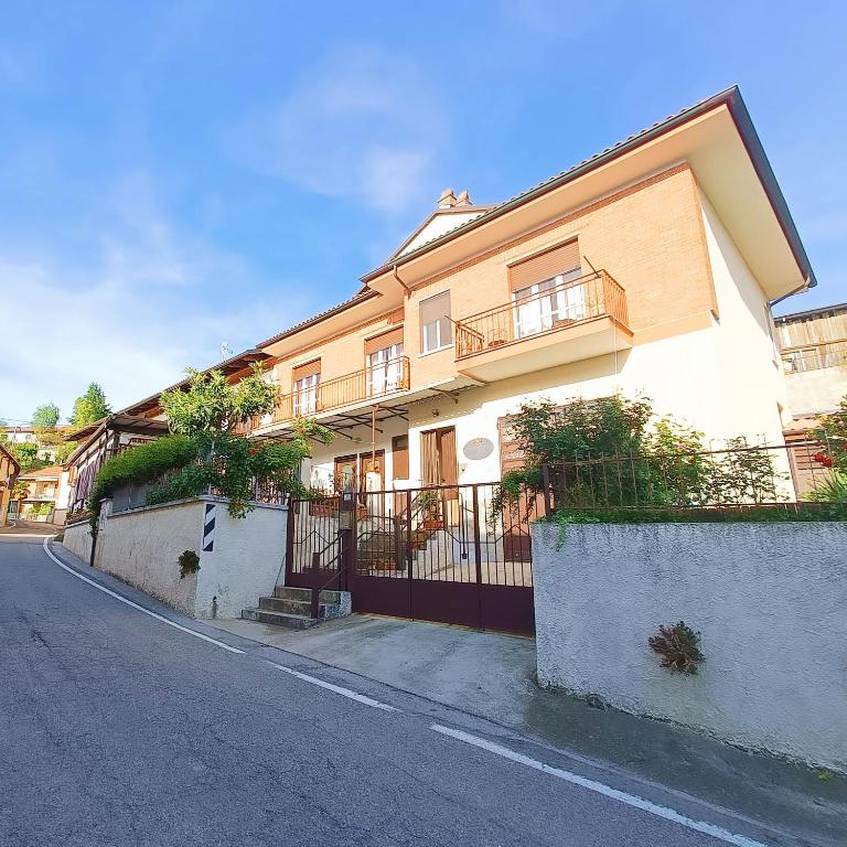a large building with balconies on the side of a street at Affittacamere San Rocco in Aramengo
