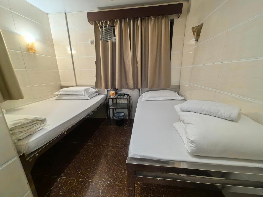 Postel nebo postele na pokoji v ubytování Hong Kong Sun Guest House