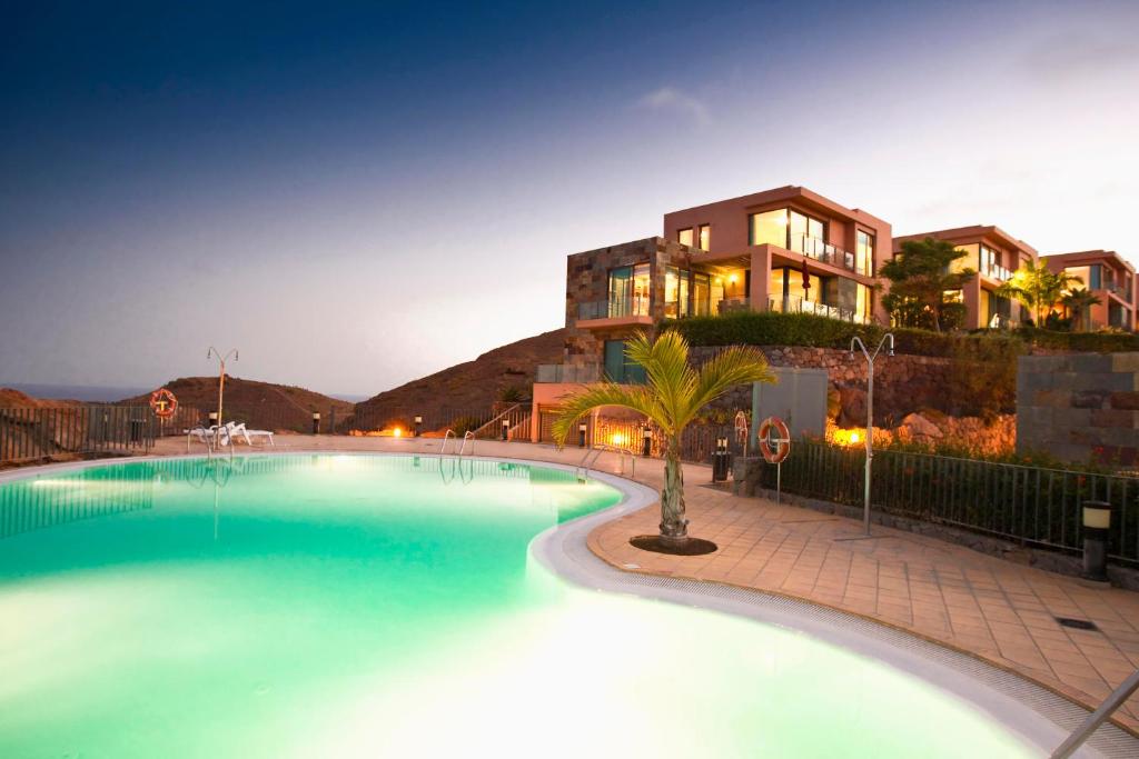 a large swimming pool in front of a building at Los Lagos 37 by VillaGranCanaria in Las Palmas de Gran Canaria