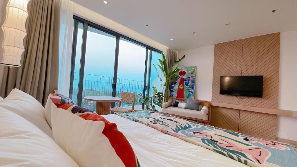 Habitación de hotel con cama grande y TV en Reverie Sky Home An Bang Beach, en Dien Ban