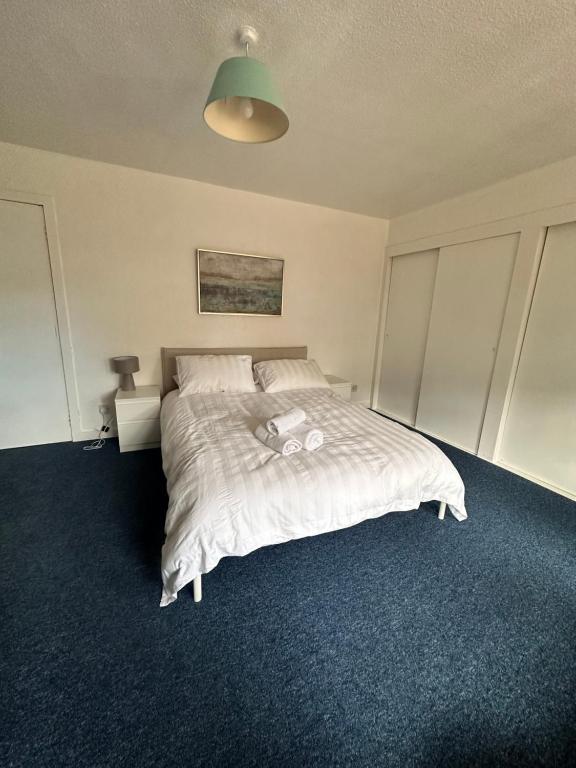 a bedroom with a bed with a white comforter at Gilcomston Park in Aberdeen