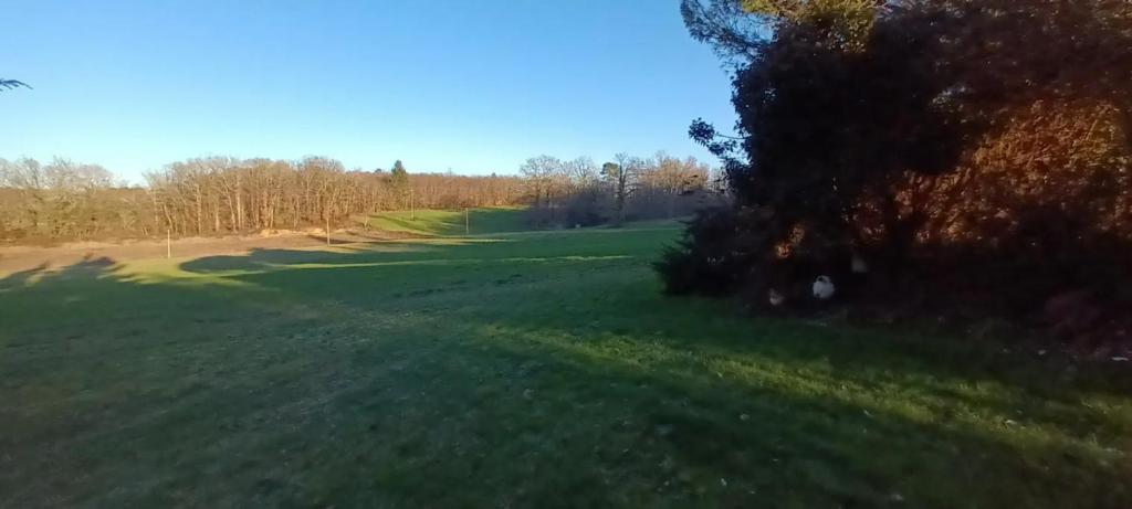 an overhead view of a golf course with trees and grass at Gîtes et chambres croix du sud in Saint-Amand-de-Vergt