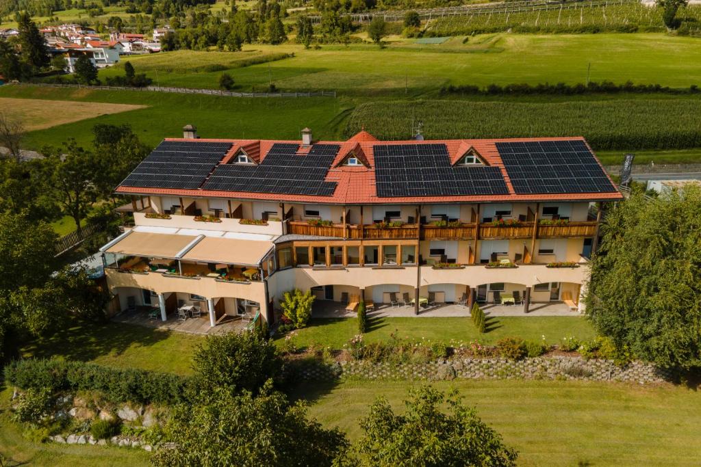 an aerial view of a house with solar panels on its roof at Margun - Apartments & PanoramaRooms in Malles Venosta