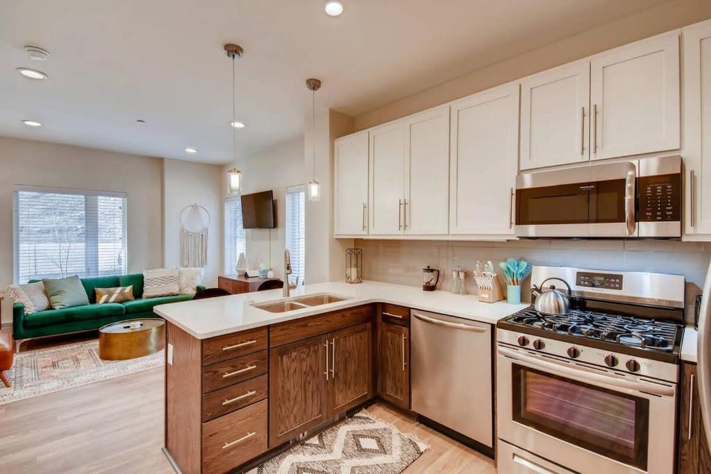 a kitchen with white cabinets and a stove top oven at Hiker's Haven Close to Slopes Georgetown in Georgetown