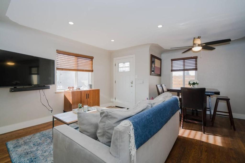 a living room with a white couch and a tv at 4-Bed Gem near Sloan's Lake in Denver