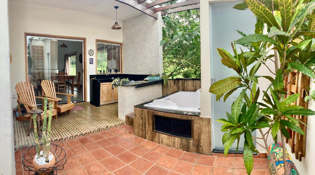 a large bathroom with a tub and a sink at Casa Janela Verde in São José da Barra