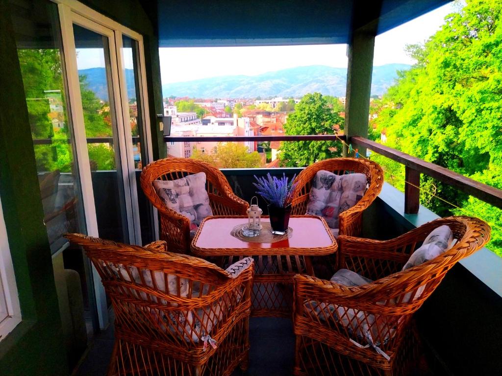 a table and chairs on a balcony with a view at Apartman Jasmin in Vrnjačka Banja