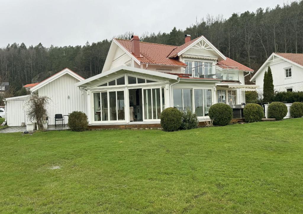 a large white house with a large yard at Exclusive villa with sea view in Uddevalla in Uddevalla