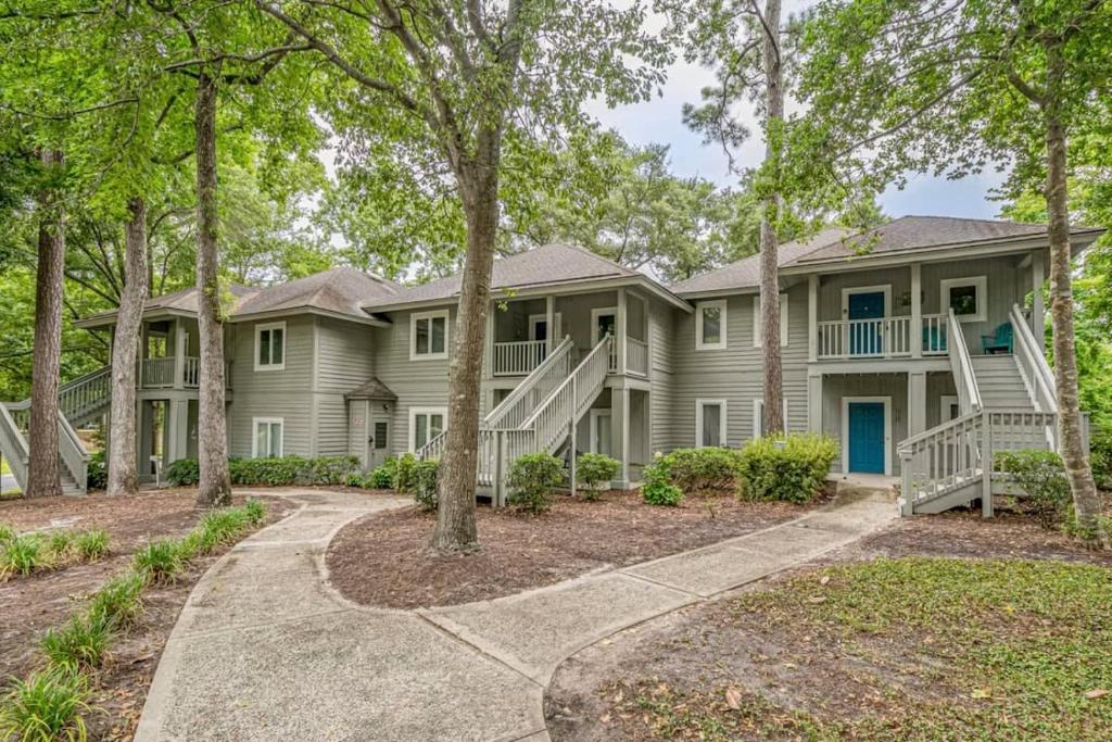 a large house with trees in front of it at Teal Lake Villas 1523 Golf Villa in North Myrtle Beach