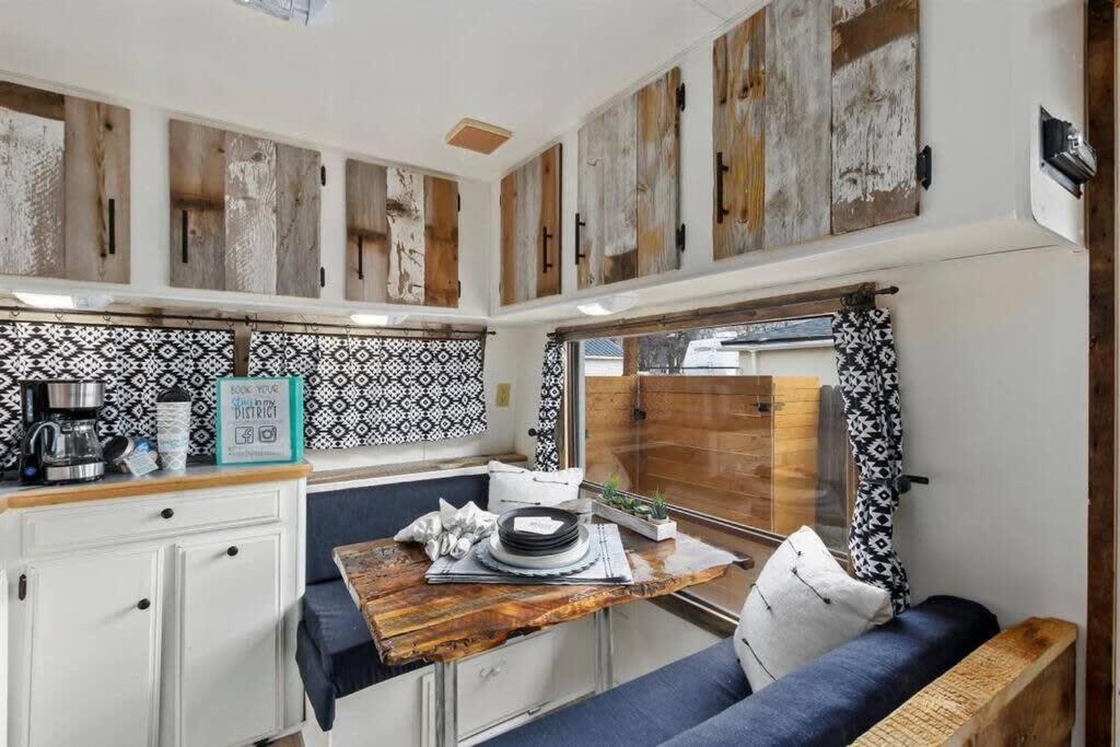 a kitchen with a table and a blue couch at #StayinMyDistrict Twin Falls Backyard Glamper in Twin Falls