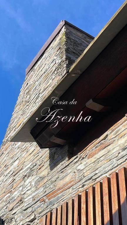 a sign on the side of a building at Casa da Azenha- Riverside Retreat by Paiva River Beach in Paradinha