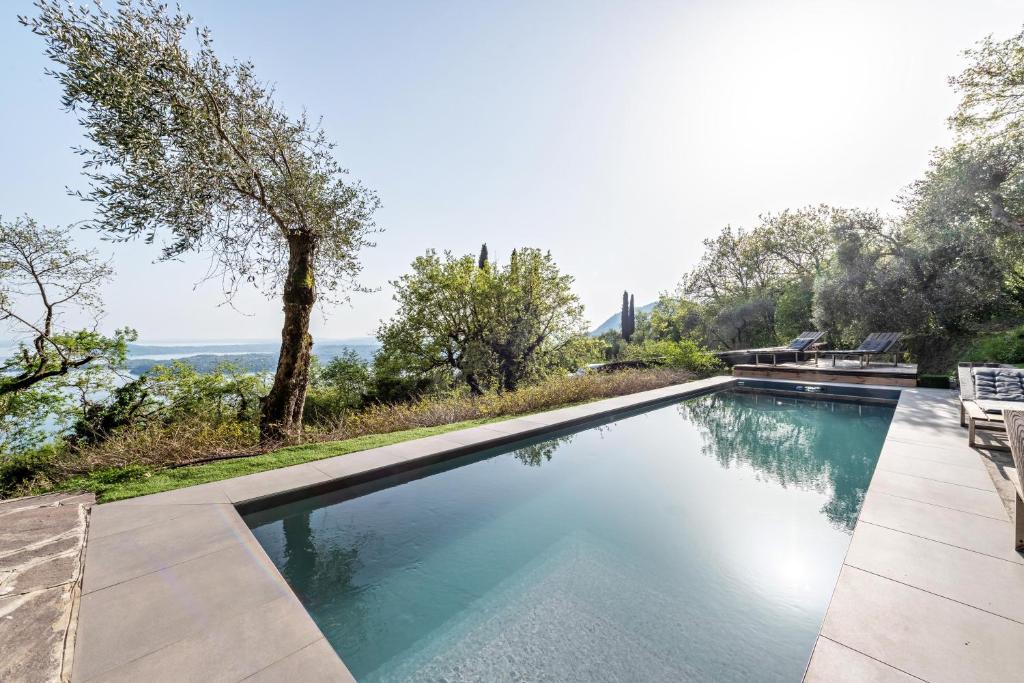 a swimming pool with a view of the ocean at Villa Artista in Gardone Riviera