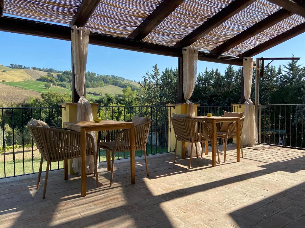 a patio with a table and chairs on a deck at B&B Casa Contento in Arcevia