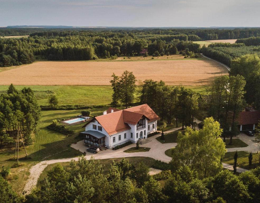 an aerial view of a house with a field at Willa Bizorenda in Małogoszcz