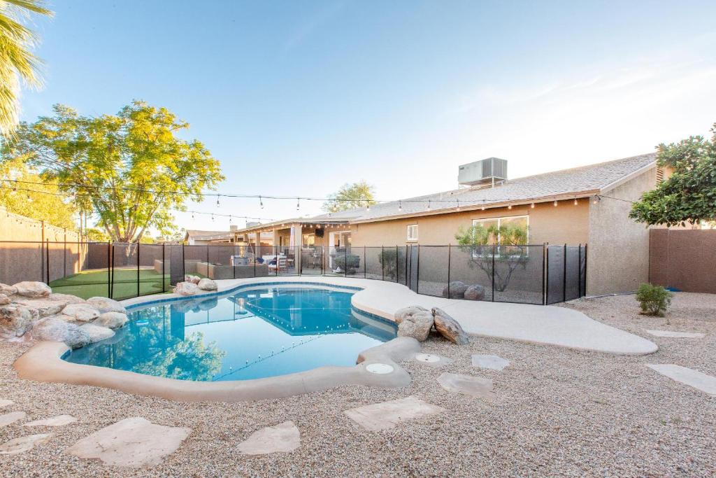 a swimming pool in the backyard of a house at Scottsdale - 15035 N 54th St in Phoenix