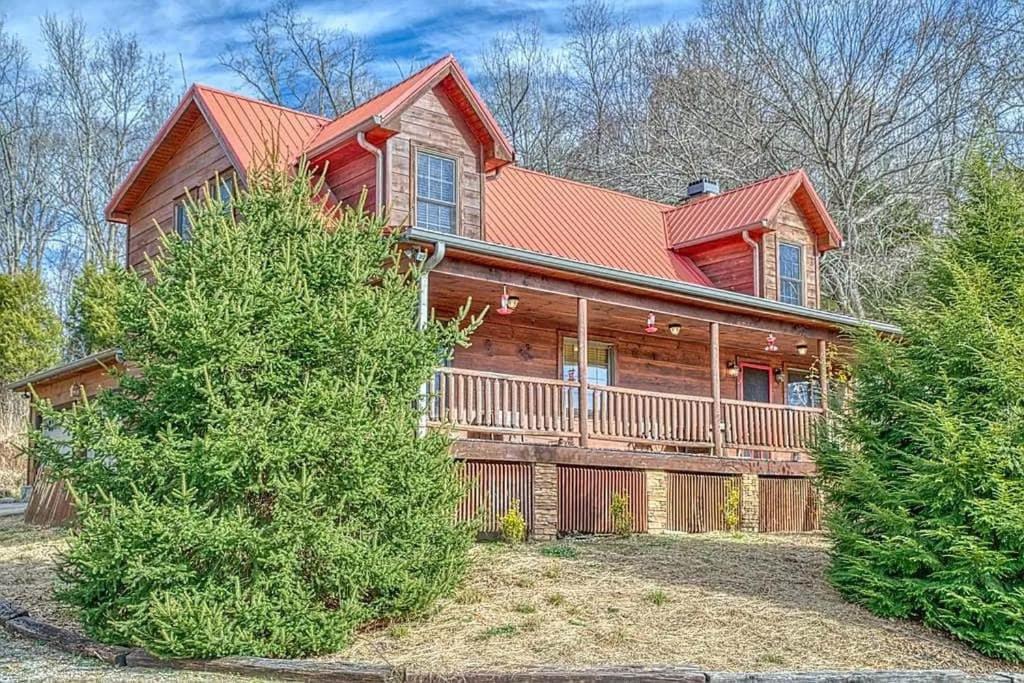a large wooden house with a large porch at The perfect hideaway just outside of Algood and minutes to Cookeville!!! in Cookeville