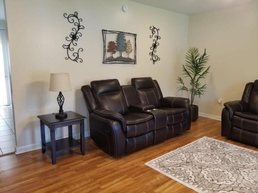 a living room with two leather chairs and a table at Spacious 3BR 2BA 11 mins away from Cummins Falls State Park!!! in Cookeville