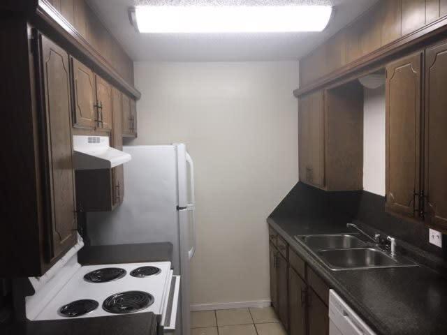a kitchen with a white refrigerator and a sink at One bedroom close to Fort Sill! in Lawton