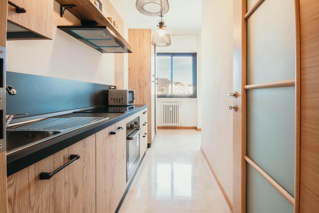 a kitchen with a sink and a stove at Appartamento Panorama - Affitti Brevi Italia in Varese