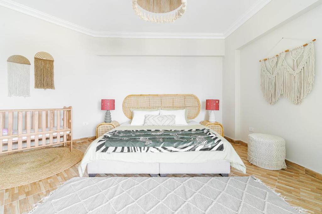 a white bedroom with a large bed in it at Nabeel Homes Boutique Hotel - B9 in Alexandria