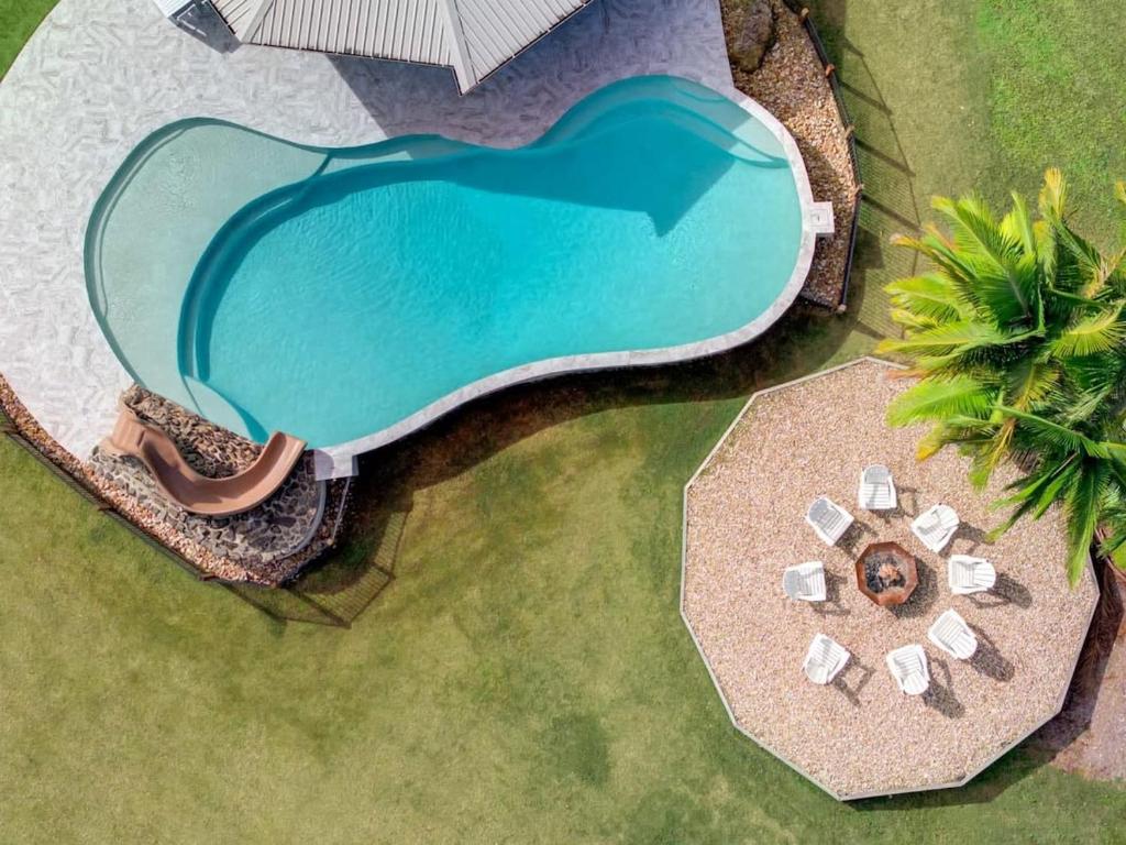 an overhead view of a swimming pool next to a beach at The Noosa Ranch- Where Nature meets Luxury in Tinbeerwah