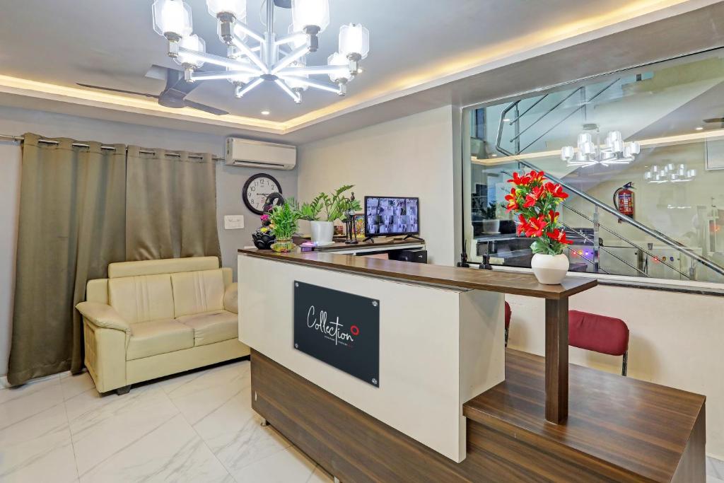 a dental office with a reception desk and a chair at Hotel White Ridge Near Kondapur in Kondapur