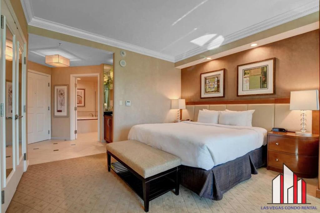 a large bedroom with a large bed and a hallway at MGM Signature-02-604 Jacuzzi Studio in Las Vegas
