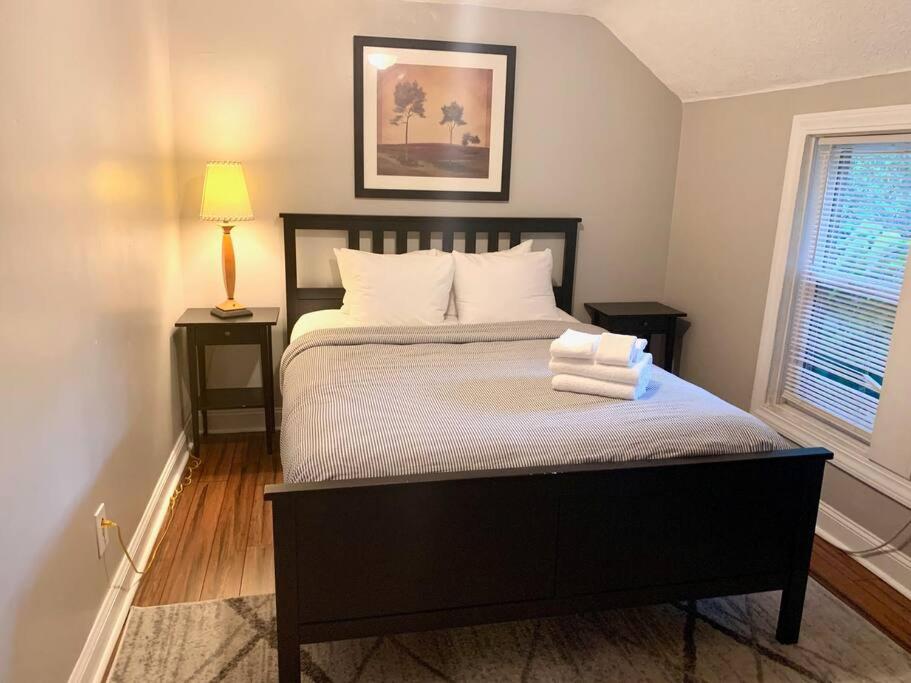 a bedroom with a bed with two towels on it at The House Hotels - W45th Backhouse - Ohio City District Home - 5 Minutes from Downtown in Cleveland
