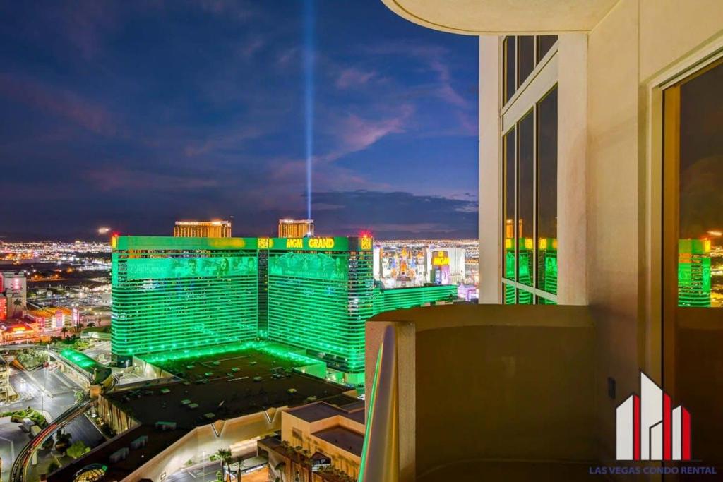 a building that is lit up green at night at MGM Signature-29-602 1Br 2Ba Balcony Jacuzzi Suite in Las Vegas