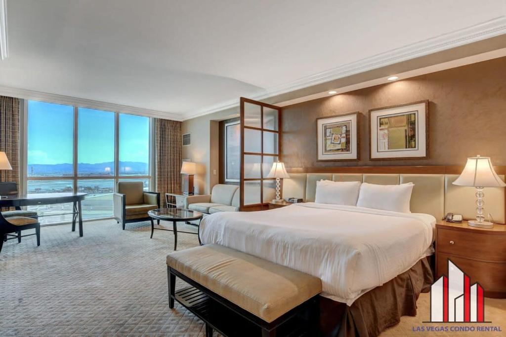 a hotel room with a large bed and a large window at MGM Signature-17-718 Jacuzzi Studio in Las Vegas