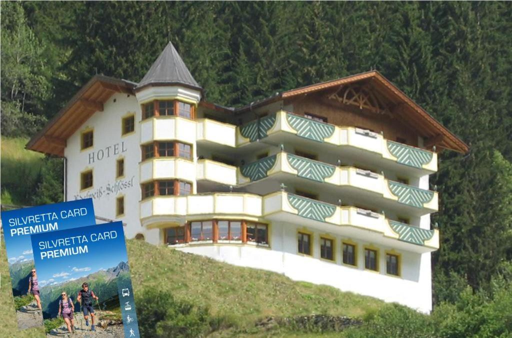 a large building on top of a hill at Hotel Edelweiß-Schlössl in Kappl