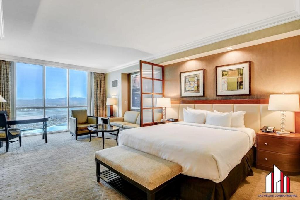 a hotel room with a large bed and a desk at MGM Signature-24-606 Jacuzzi Studio in Las Vegas