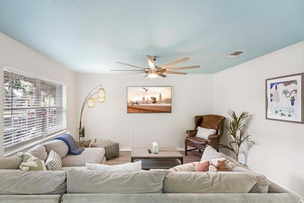 a living room with a couch and a ceiling fan at Uptown Gem The Castaway Cottage, Dog Friendly! in Saint Augustine