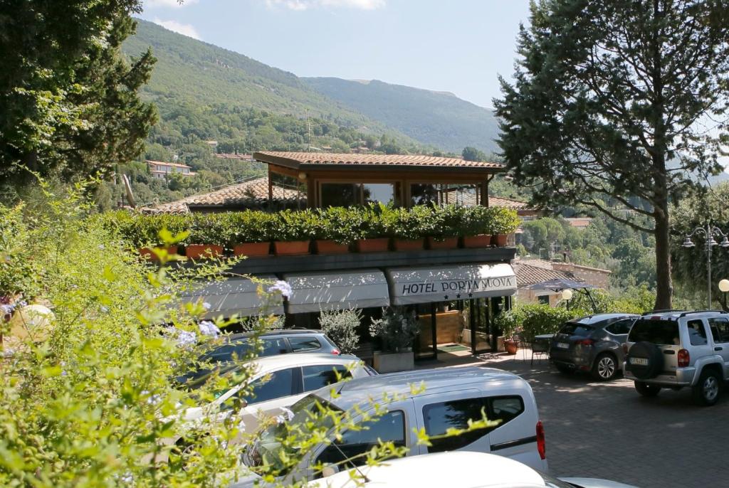 a parking lot with cars parked in front of a building at Hotel Porta Nuova in Assisi