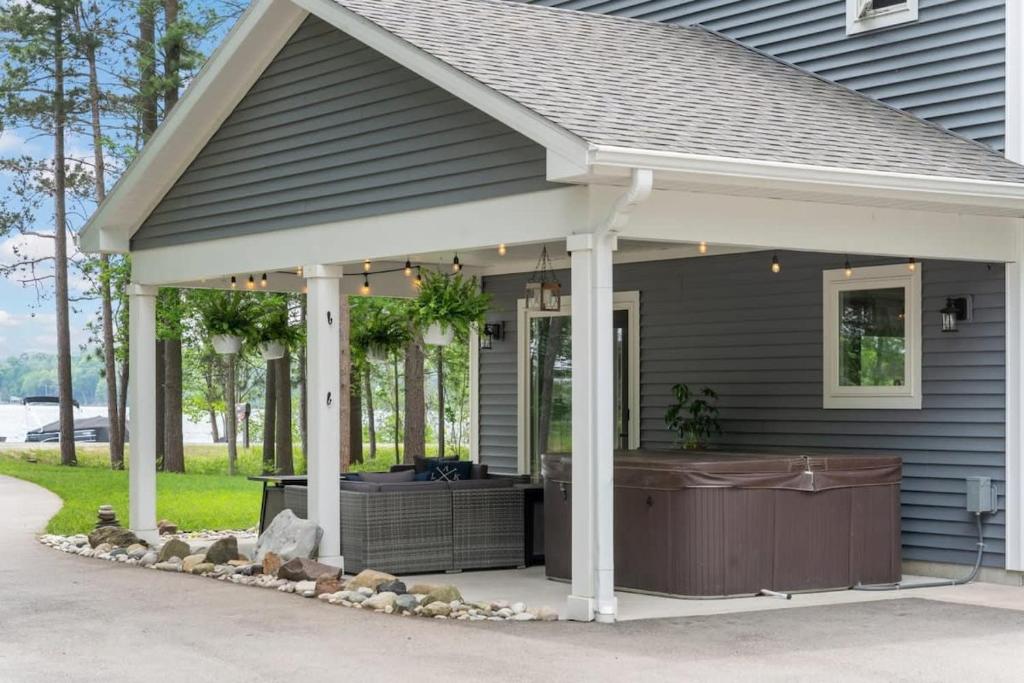 a barbecue under a pavilion on a house at Long Lake Dream Dogs Welcome in Traverse City