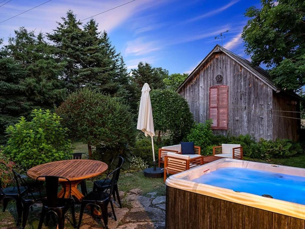 a backyard with a table and a swimming pool at The Gem - Beautiful farmhouse with hot tub in West Lake