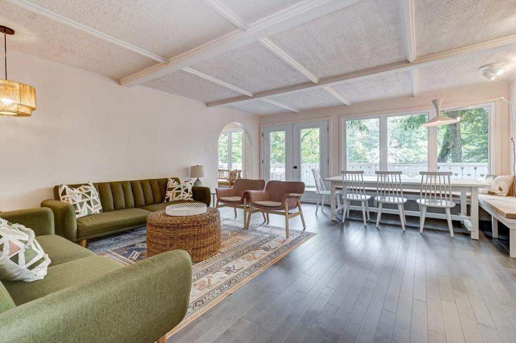 a living room with green couches and a table at Family chalet in the heart of Wakefield in Wakefield