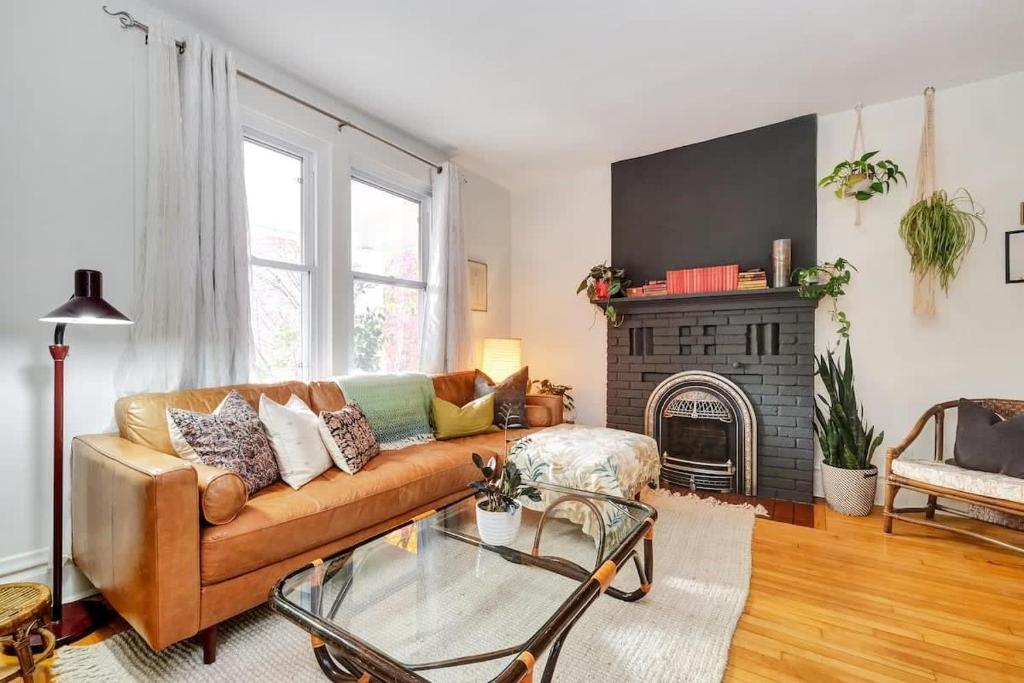 a living room with a couch and a fireplace at Century home by river hot tub & parking in Ottawa