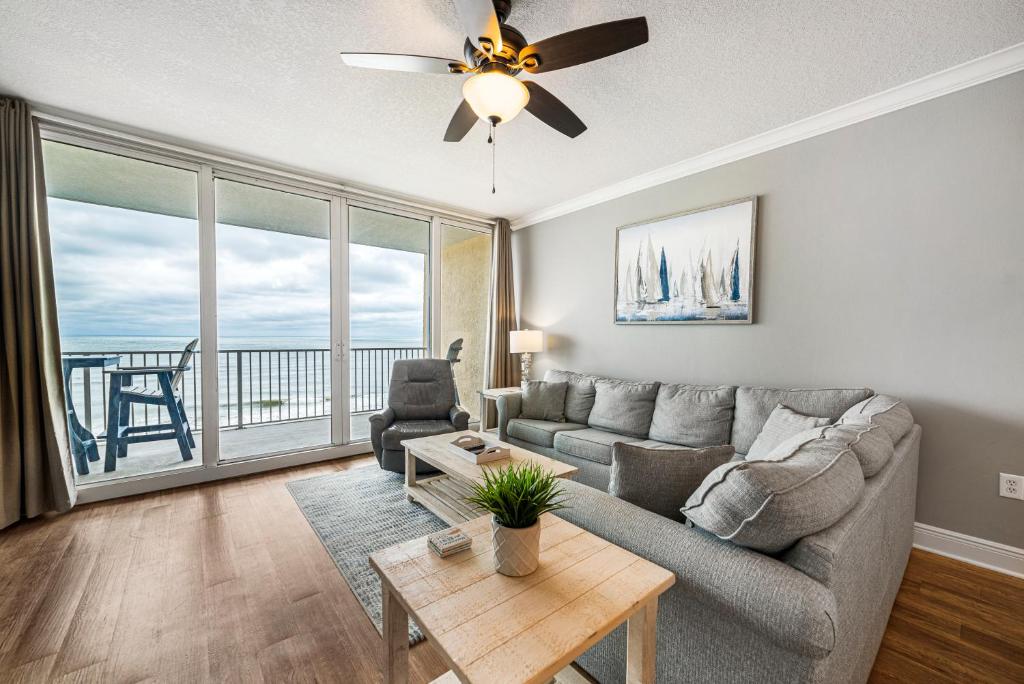 a living room with a couch and a ceiling fan at San Carlos 608 in Gulf Shores