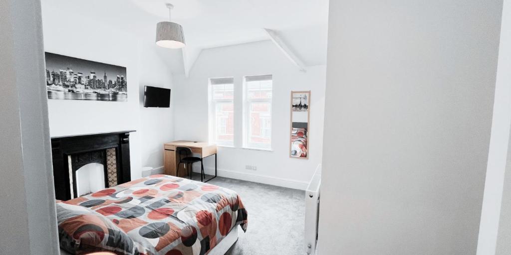 a bedroom with a bed and a fireplace at Large Room in Modern House near Nottingham in Nottingham