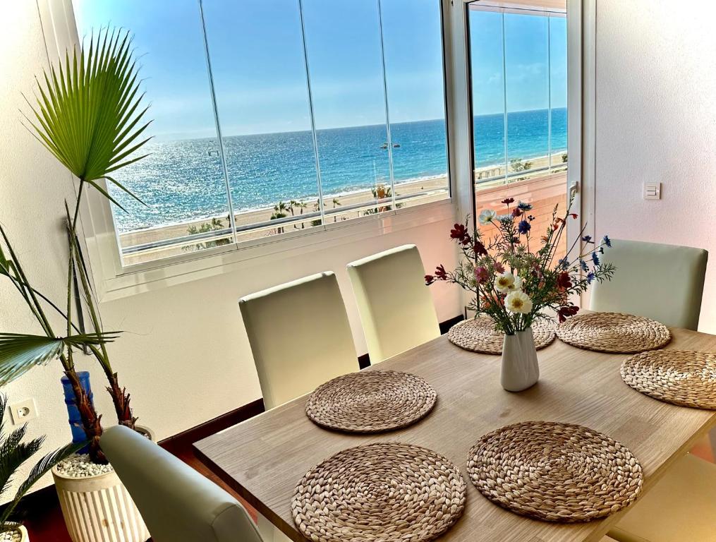a dining room with a table with a view of the ocean at Vista del Mar Residencial in Roquetas de Mar
