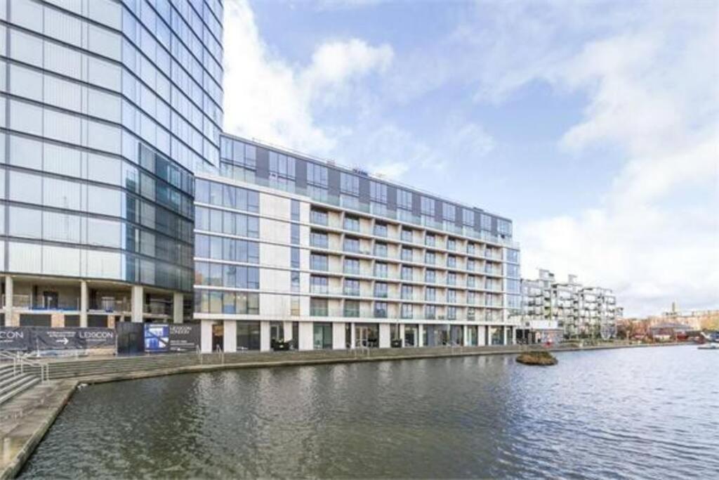 a large building next to a body of water at Modern apartment w/ canal view in London