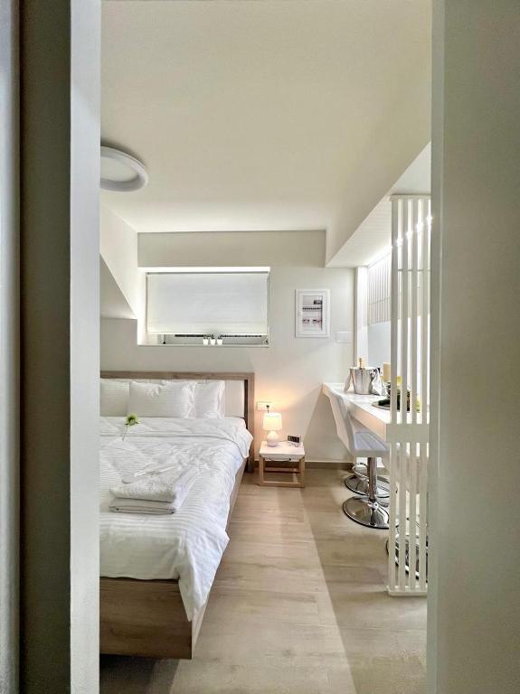 a bedroom with a bed and a desk in it at Central Luxury Flat 1 in Chios