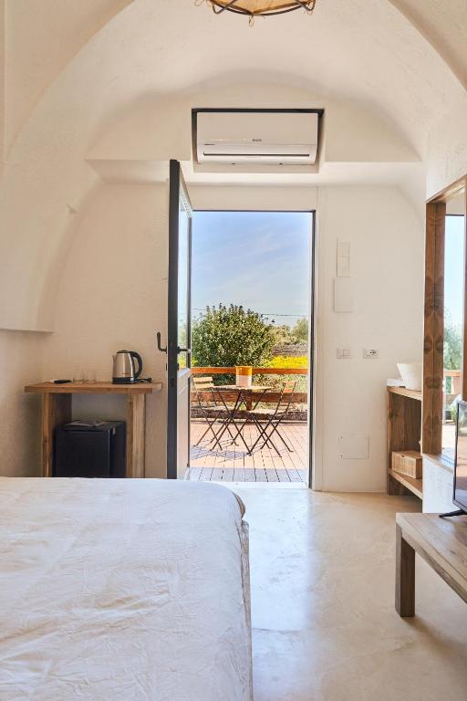 a bedroom with a bed and a view of a patio at Il Trappetello in Monopoli