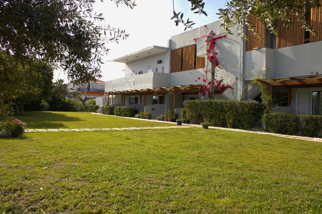 a building with a lawn in front of it at Kalamaki Plaza Apartments in Kalamaki