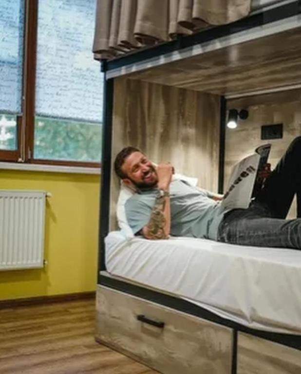 a man laying on a bed in a bunk bed at Hostel,halal in Tokmok